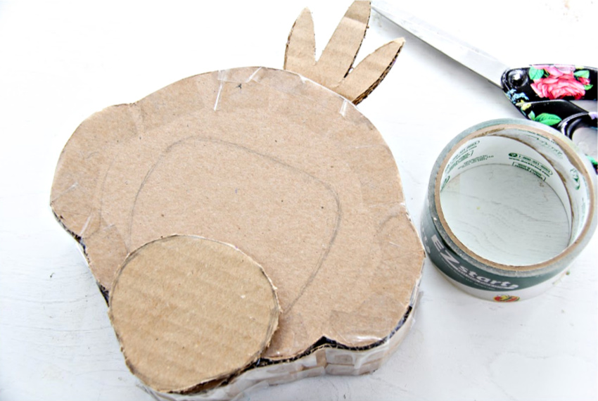 A cardboard monkey pinata being made.