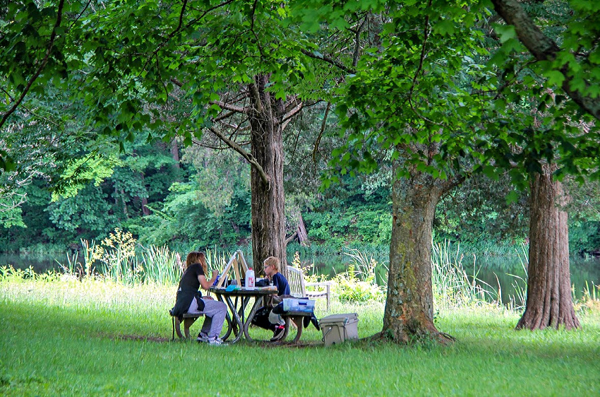 kids painting on canvas out in nature