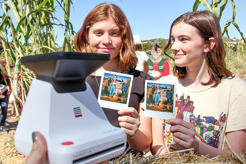 Girls holding polaroid style photographs printed with the Polaroid Lab.