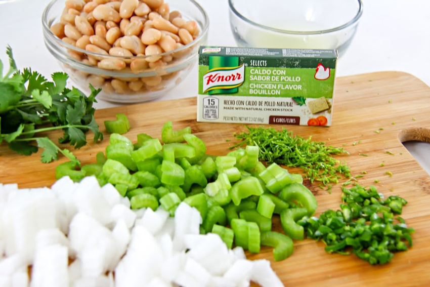 Knorr chicken bouillon with diced celery and onion, fresh herbs and beans