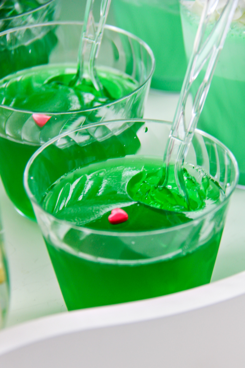 green jelly with red candy hearts in cups