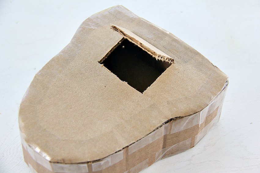 a flap cut into cardboard for a pinata