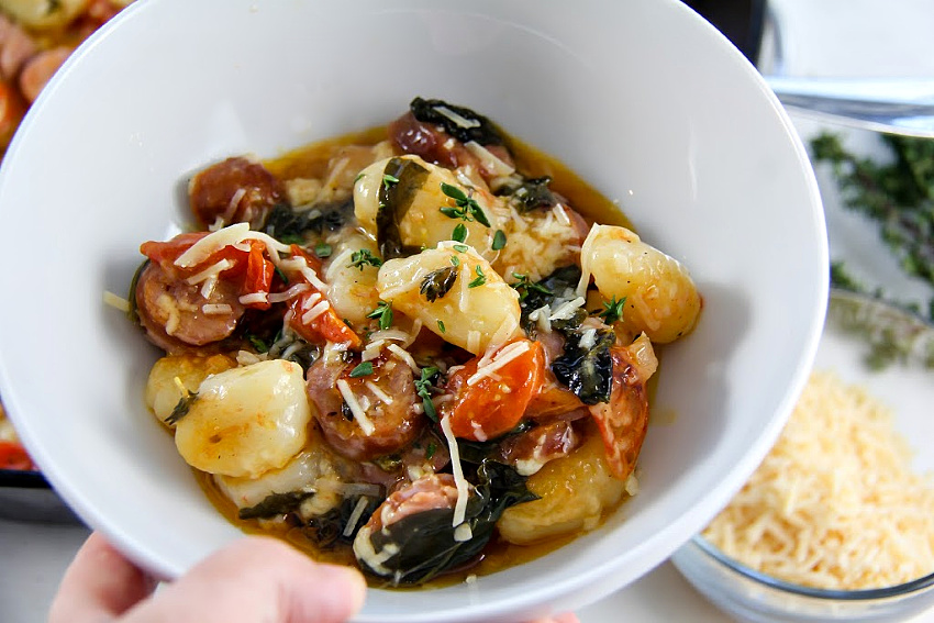 gnocchi and kielbasa in a white bowl