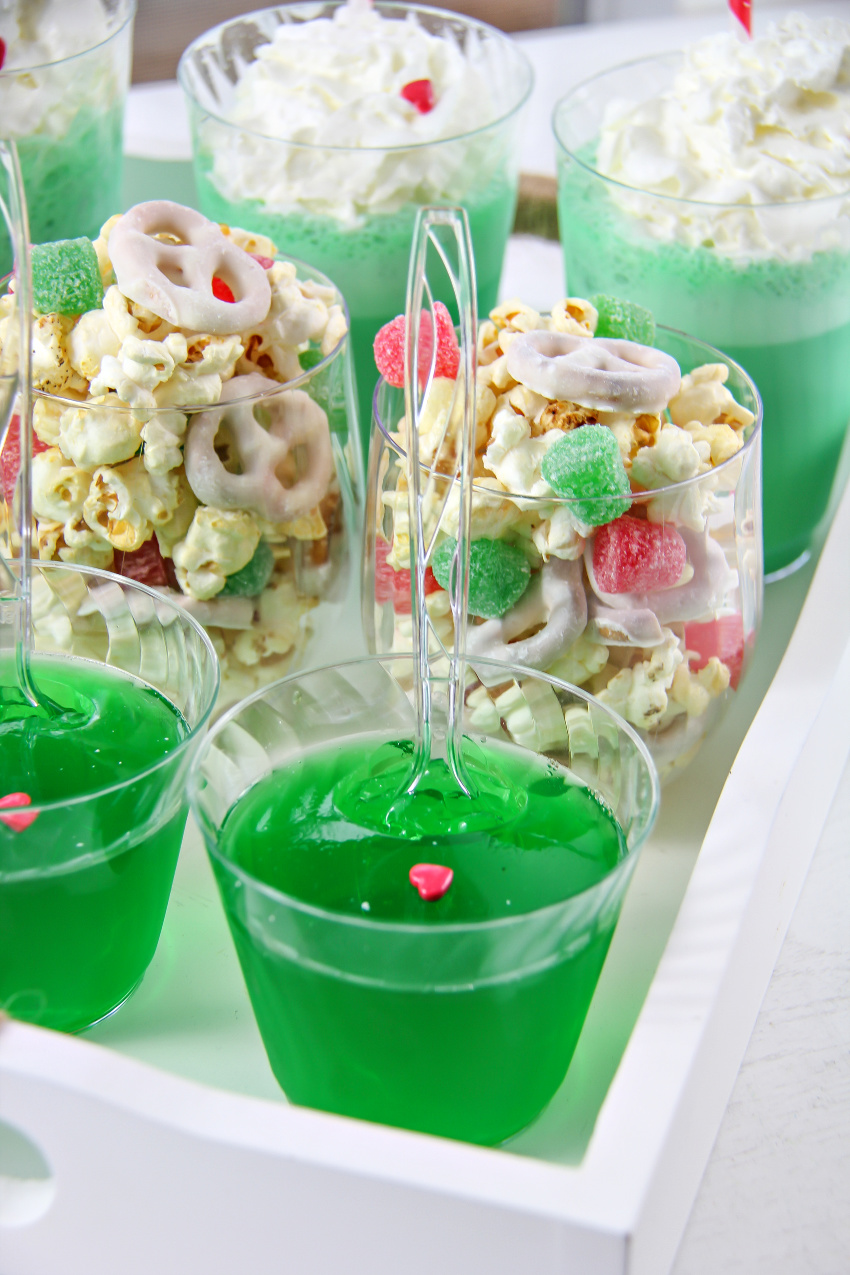 green jelly and popcorn with candy and yogurt covered pretzels in cups