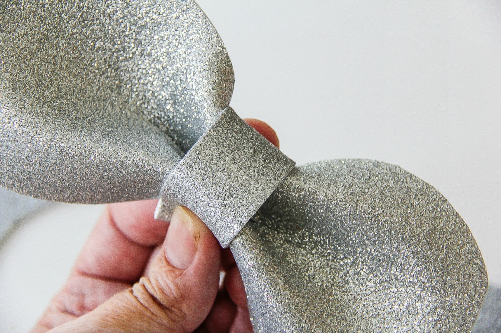 hand holding silver foam bow