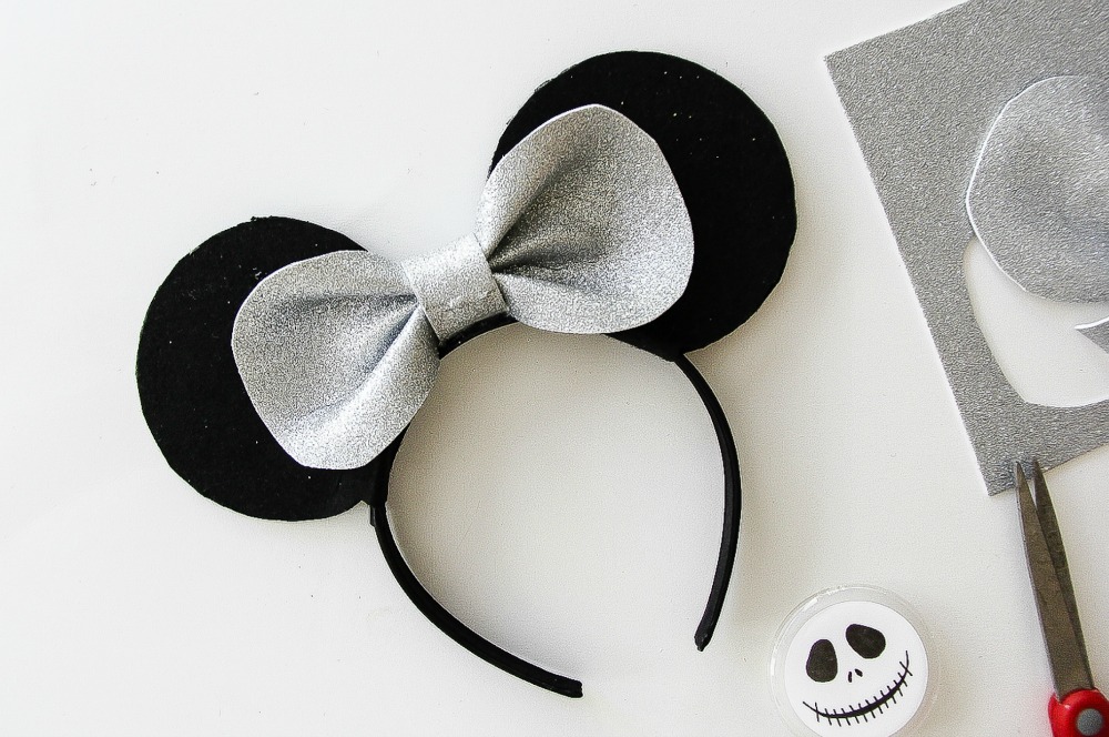 silver and black mickey mouse ear headband with a bow