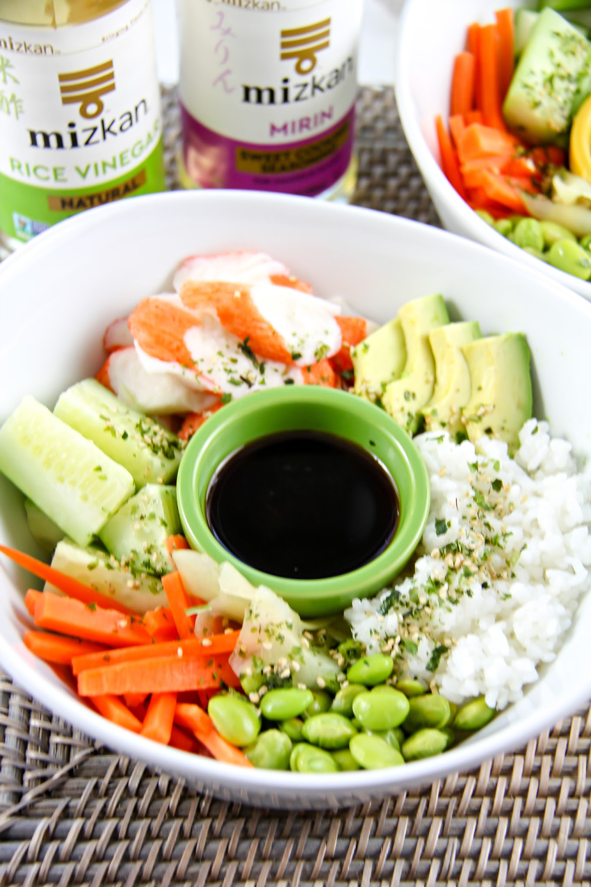 California Sushi ingredients in a white bowl on a table with Mizkan Sauces in the background