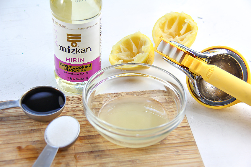 A bottle of Mizkan Mirin with lemon and other ingredients to make a sauce