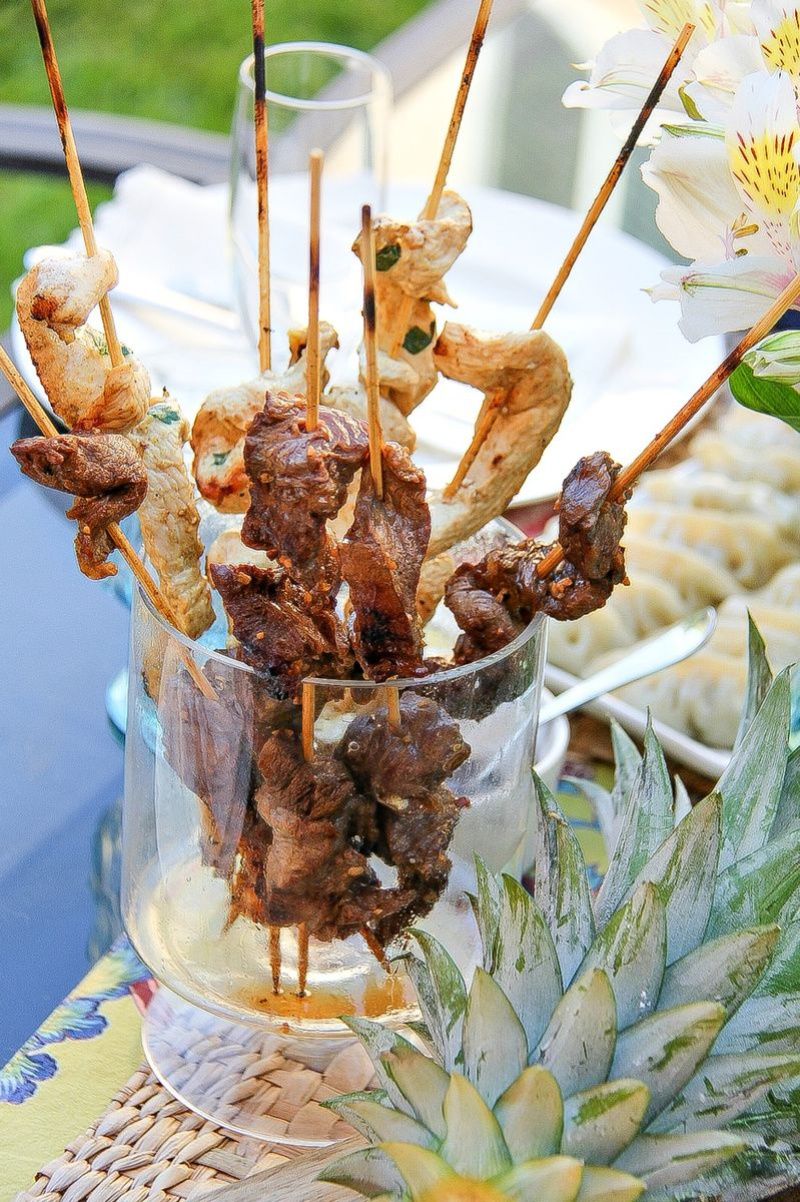 skewers with chicken and beef in a wide glass vase
