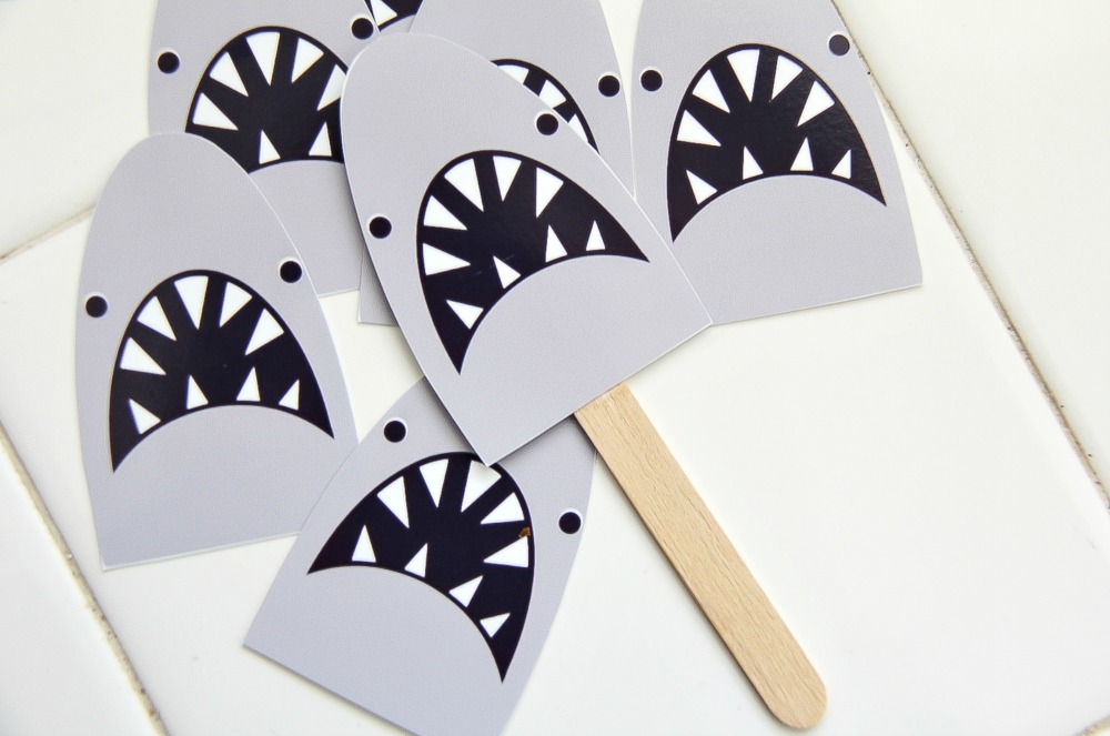 paper shark heads attached to popsicle sticks