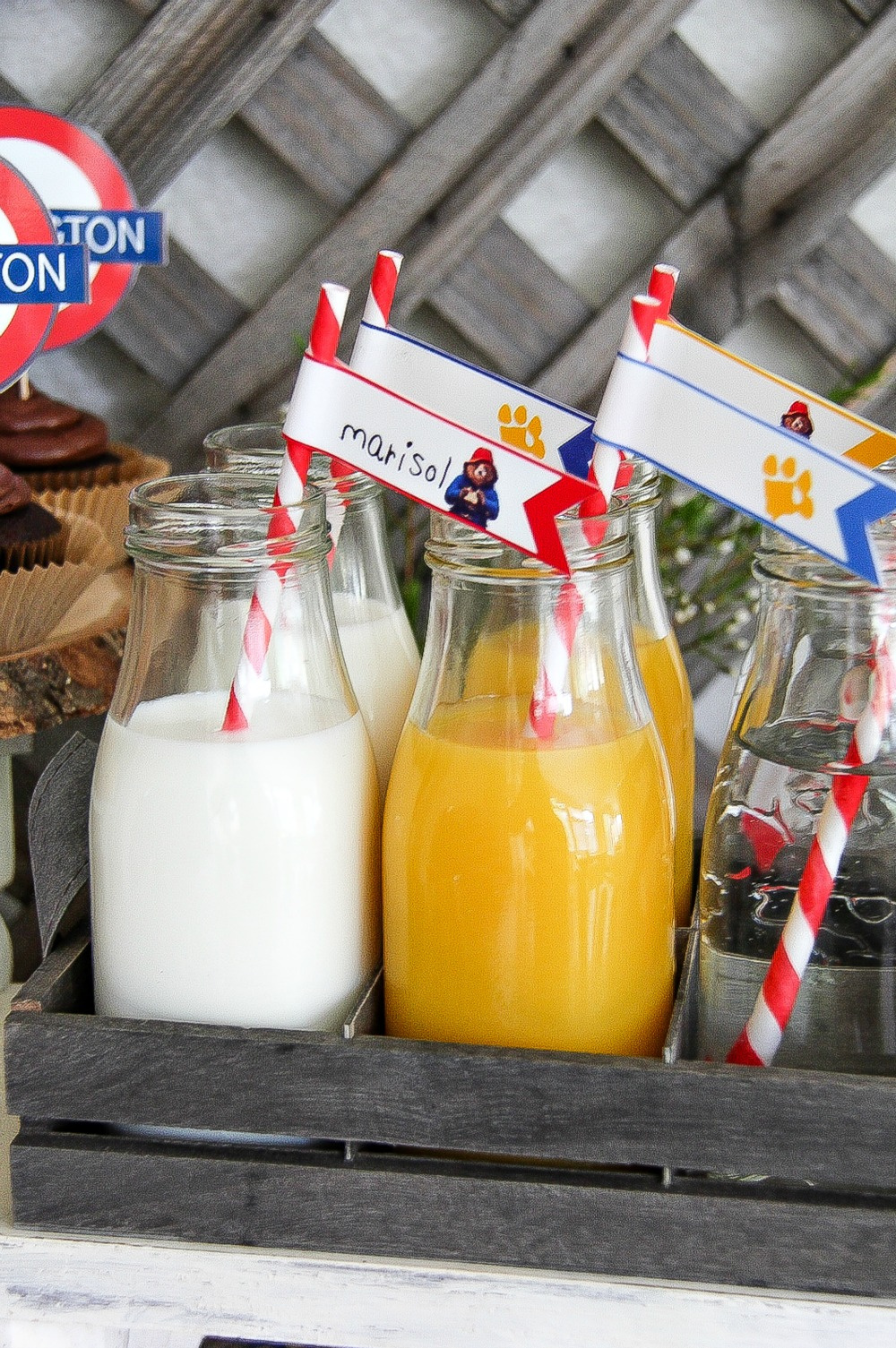 milk and orange juice in small milk bottles with flag straws with kids names on them