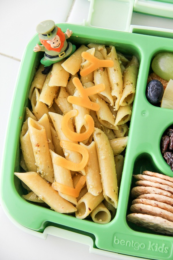 pasta with pesto in a green lunch box for kids