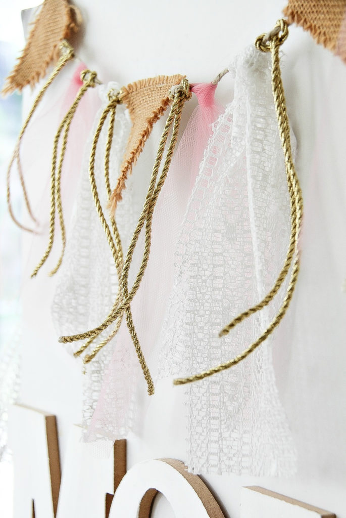 a fabric, rope, and burlap garland in pink gold and white