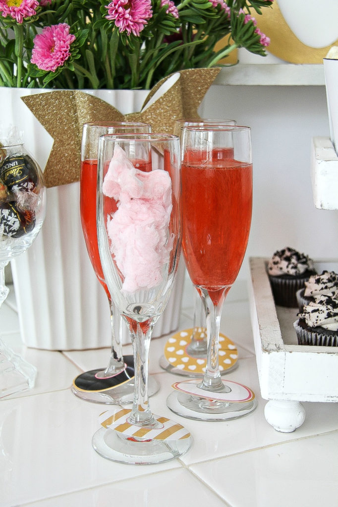 champagne glasses containing before and after of cotton candy and champagne