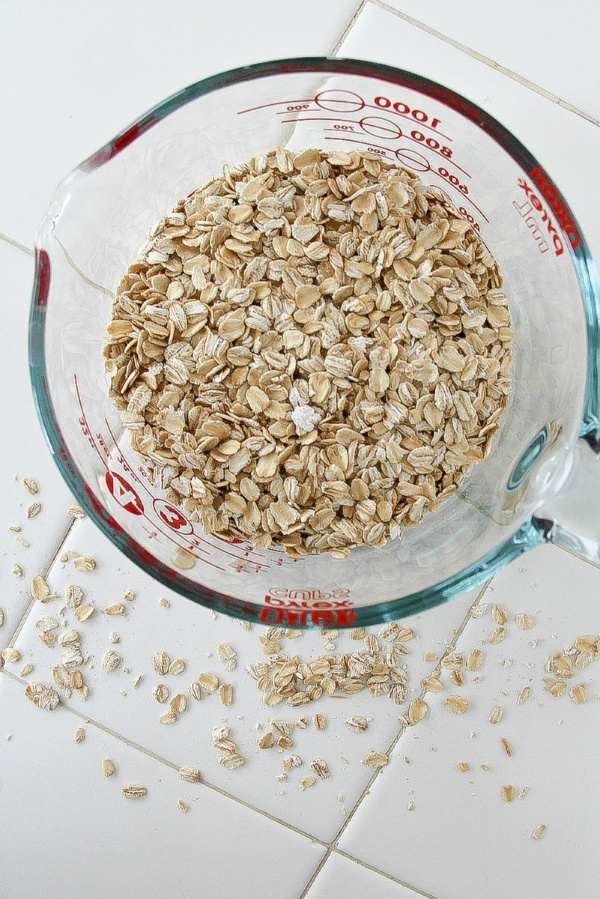 oats in a measuring cup on a white counter