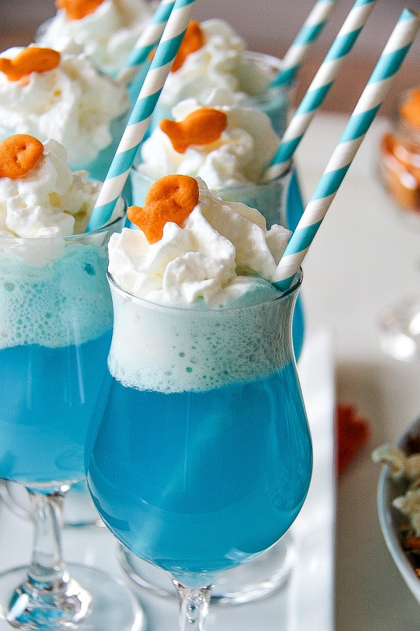 blue ice-cream floats topped with whipped cream and a Goldfish