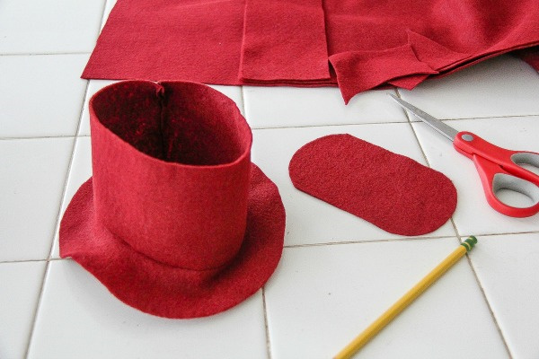 a red felt hat being made for a teddy bear