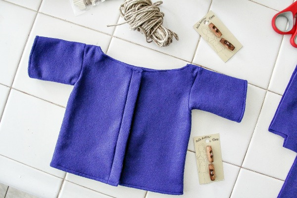 a blue felt coat sewn for a bear