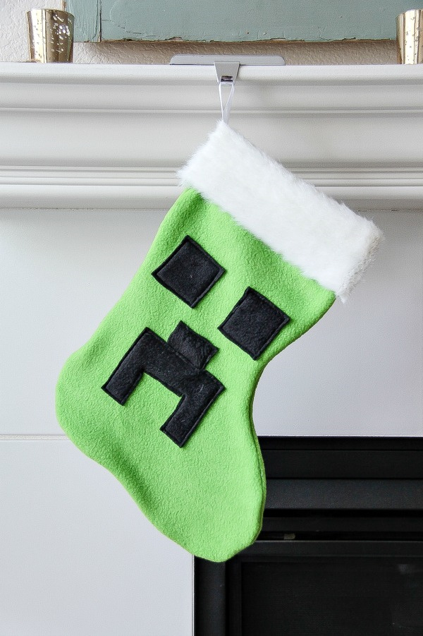 A Minecraft christmas stocking hanging from a mantel.