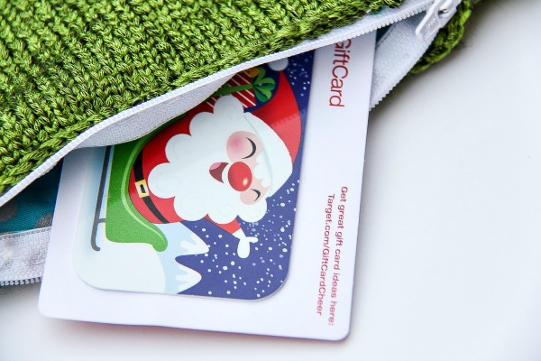 a Target gift card inside a green knit zippered pouch