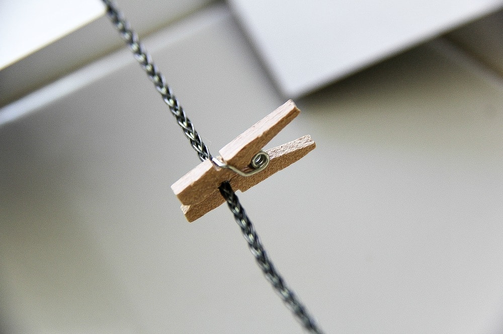 a small wood peg on a piece of wire for clipping photographs