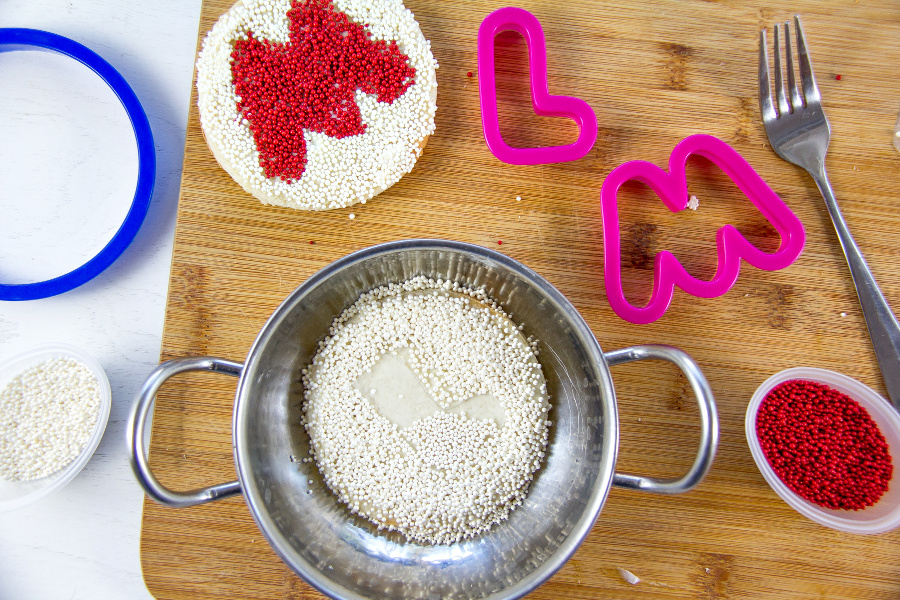 fairy bread with the letter M on it being made