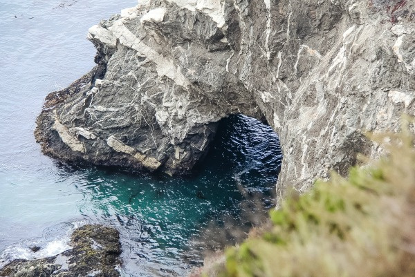 a rock bridge over the ocean