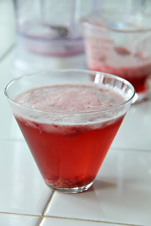 a red cocktail in a glass