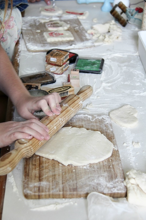 girl rolling out dough to make ornaments