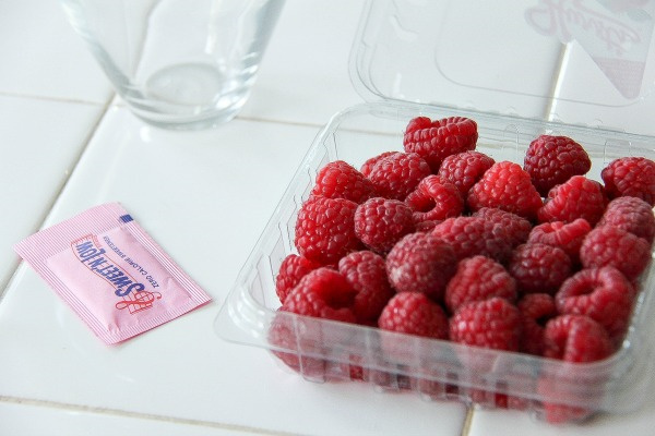 a punnet of raspberries and a packet of sweet 'n low