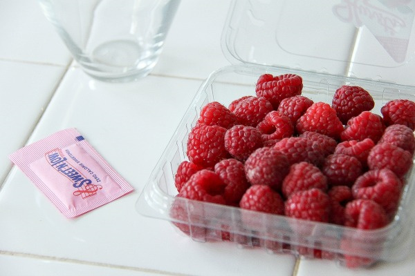 a punnet of raspberries and a packet of sweet 'n low