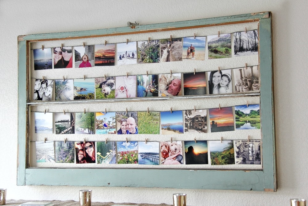 square photographs hung inside a window using wood pegs