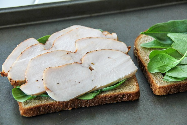 sliced turkey and spinach on whole wheat bread