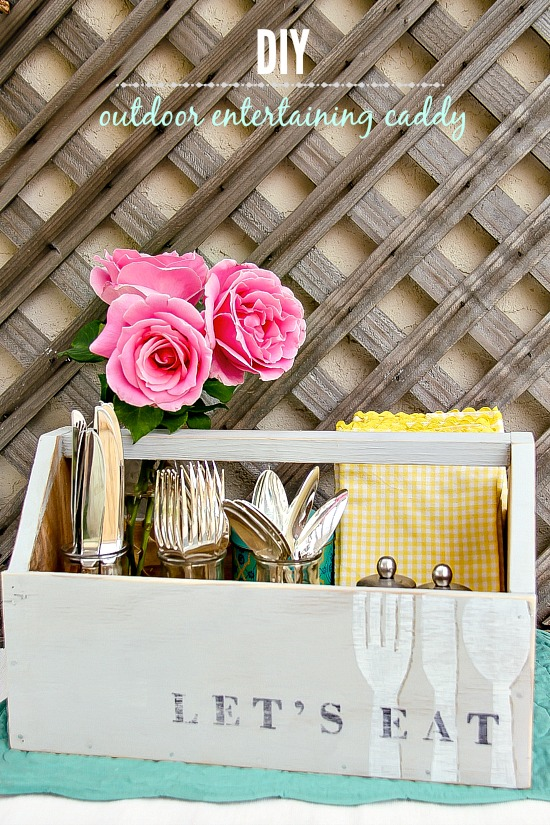 a grey wood caddy for utensils that has the words let's eat on it