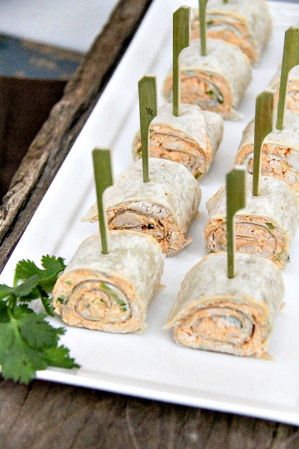 a white tray of buffalo chicken salad pinwheels