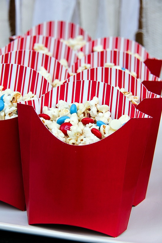 kettlecorn in red and white striped french fries tubs with red and blue M&M's inside