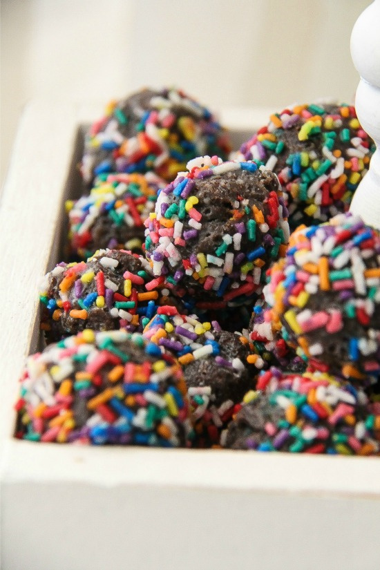 chocolate doughnut holes rolled in rainbow sprinkles