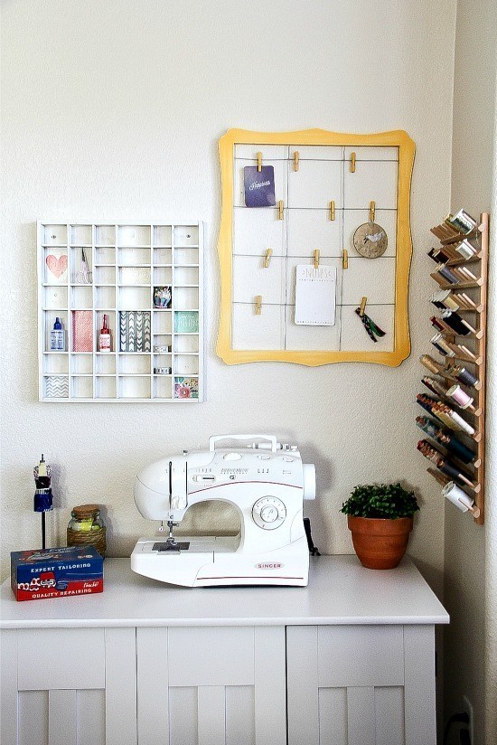 a sewing table with wood storage on the wall