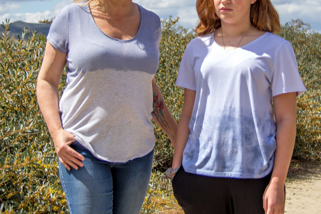 a mother and daughter wearing t-shirts that have been dip dyed with denim blue color