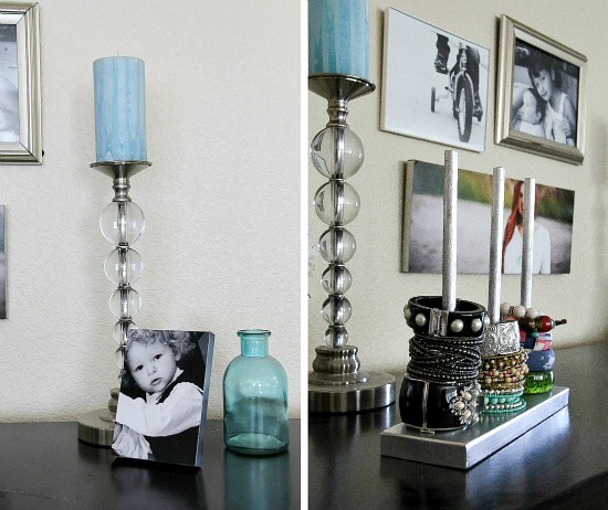 candlesticks, photo frames, and a jewelry organizer on top of a black cabinet