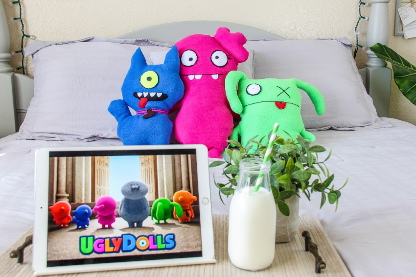 handmade ugly dolls character pillows on a bed with the movie ready to play