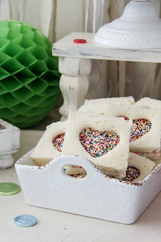 heart shaped fairy bread in a white container