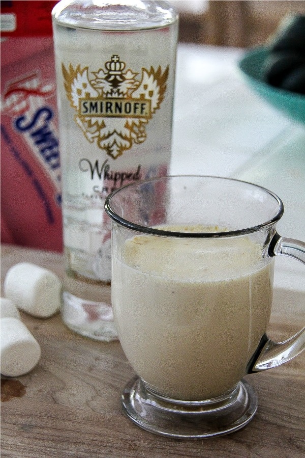 a bottle of whipped cream smirnoff vodka with a white hot chocolate