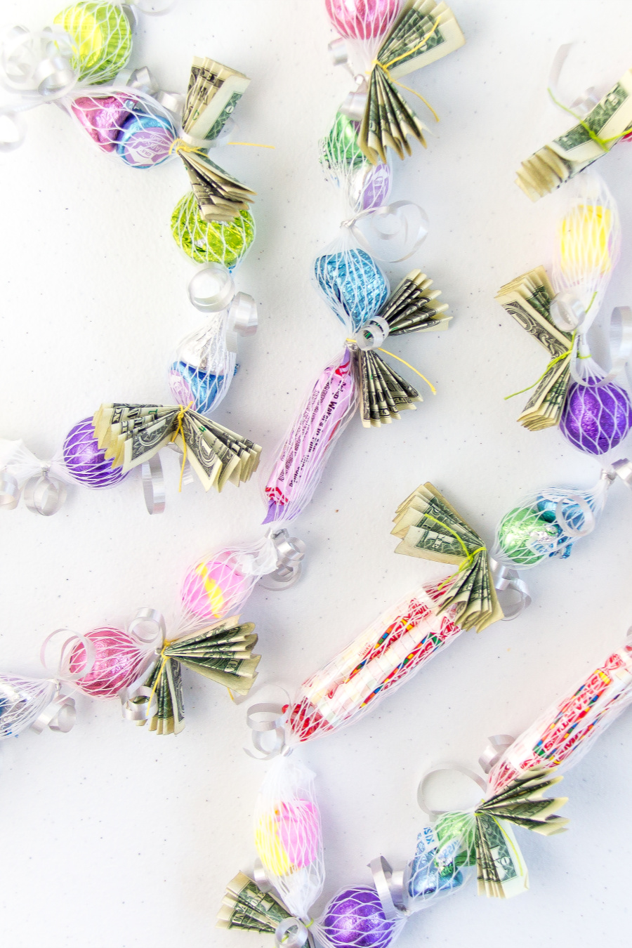 two leis made using candy and money inside a net sleeve