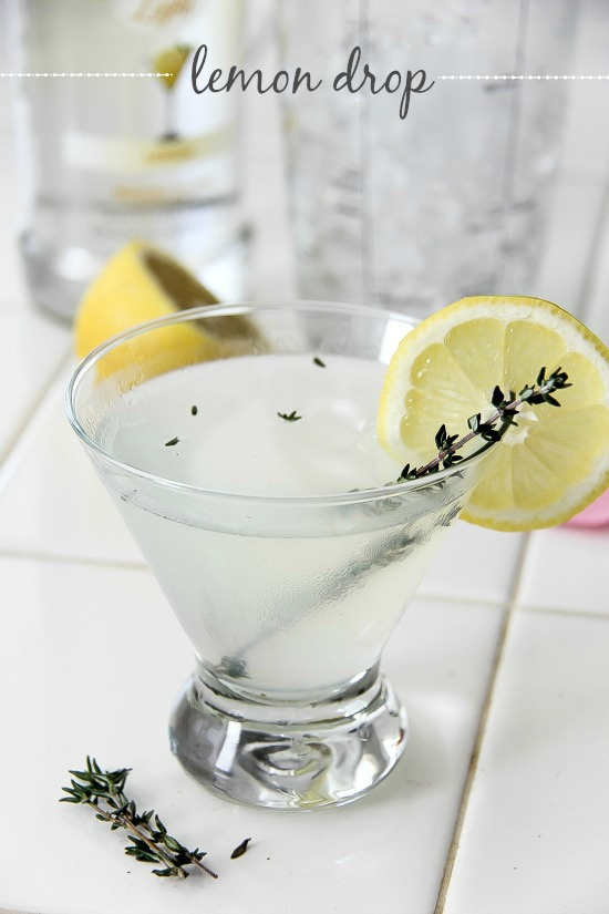 lemon drop cocktail garnished with thyme and a lemon slice