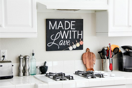 made with love chalkboard kitchen sign in a white and black kitchen