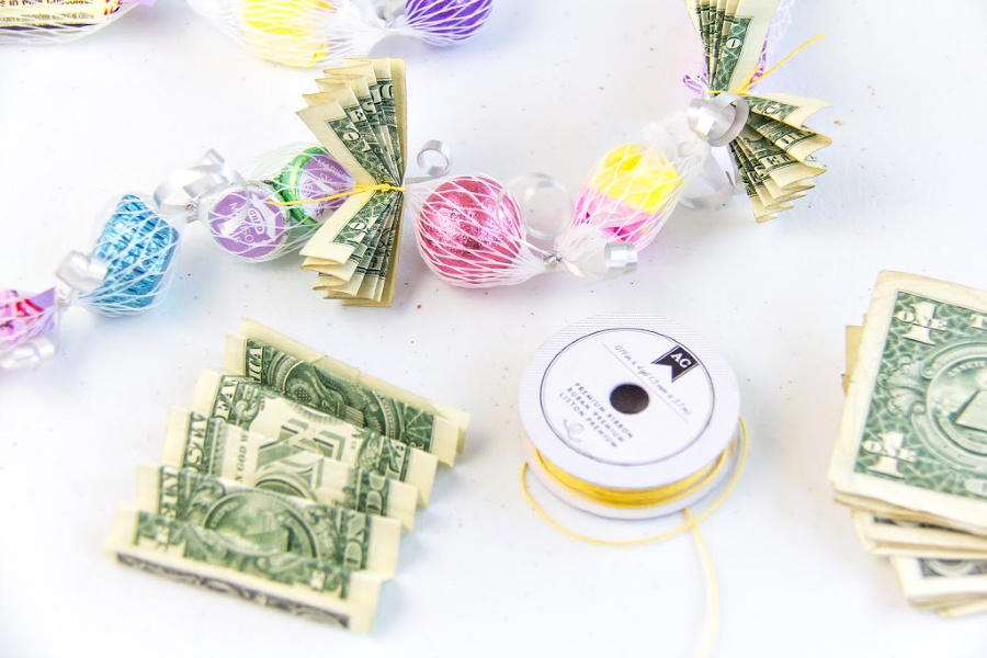 money folded and tied to a graduation lei