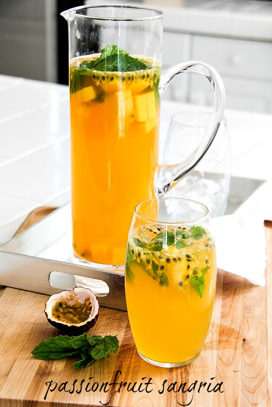 passion fruit sangria in a glass pitcher and a glass with ice