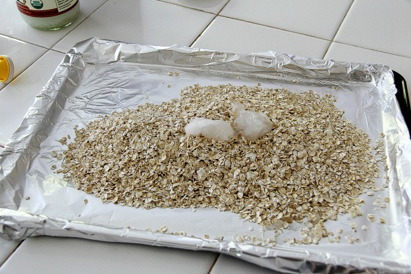 oats on a baking tray lined with aluminum foil