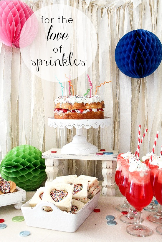 a party food table where everything has rainbow sprinkles on it